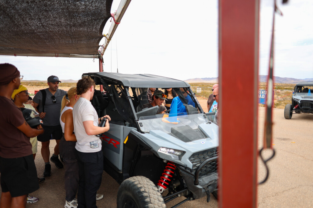 Small Group Desert Tours: 7 Essential Vegas Planning Tips 2 Guests beside a RZR before small group desert tours near Las Vegas