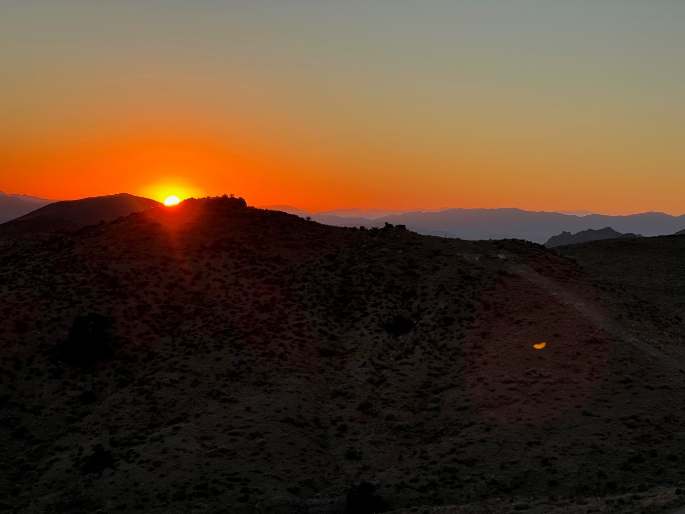 an orange sunset in the background